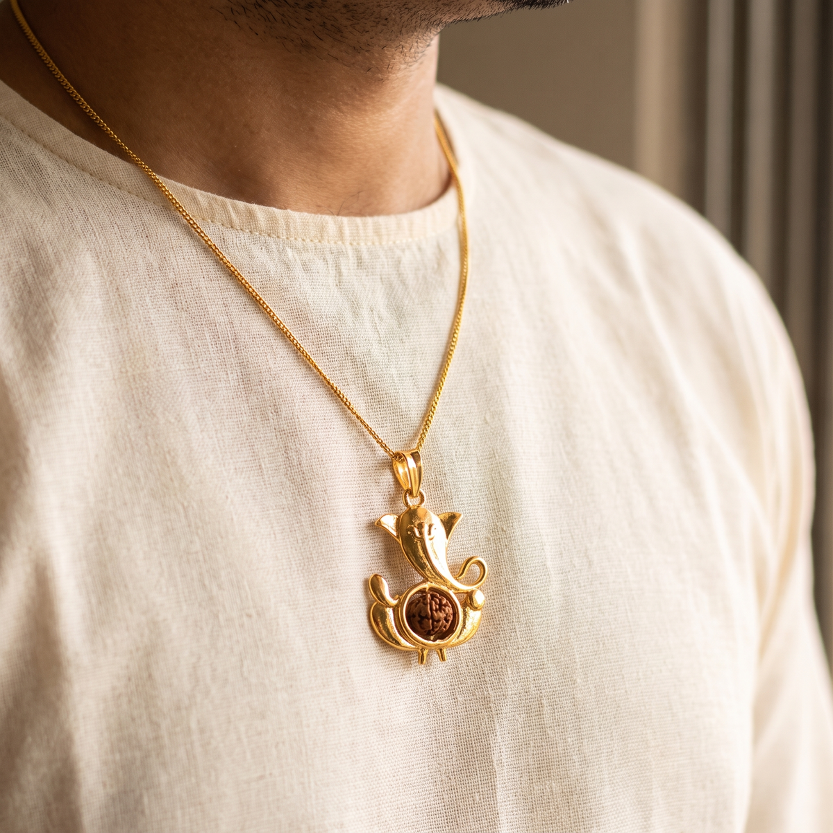 Siddhi Ganesha Rudraksha pendant worn on a gold chain