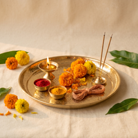 Brass pooja thali with lit diya kumkum and marigold flowers – Pooja Kits collection