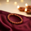 Sunstone Bracelet on maroon silk - GemsMantra
